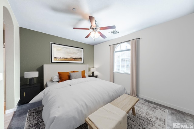 unfurnished living room featuring ceiling fan, sink, dark carpet, and a wealth of natural light