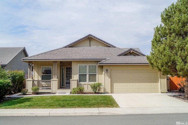 ranch-style home featuring a garage, a front yard, and covered porch