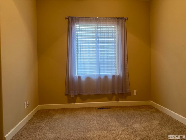 carpeted empty room with a wealth of natural light