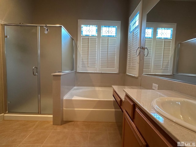 bathroom featuring plenty of natural light, vanity, tile patterned flooring, and separate shower and tub