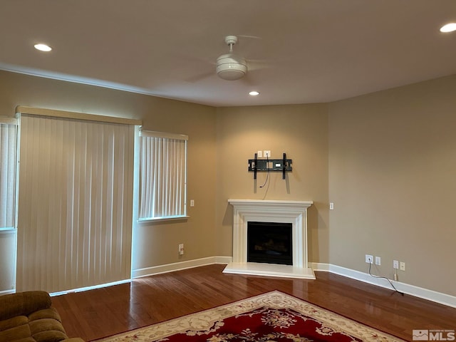 unfurnished living room with ceiling fan and wood-type flooring