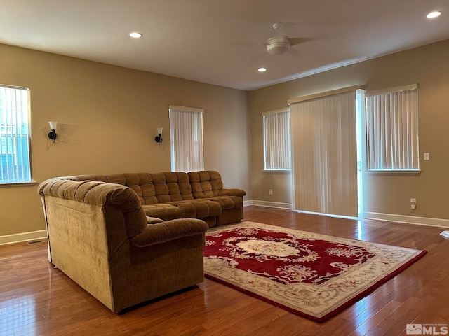 living room with hardwood / wood-style floors and ceiling fan