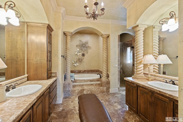 bathroom with a relaxing tiled tub, tile patterned floors, decorative columns, and vanity