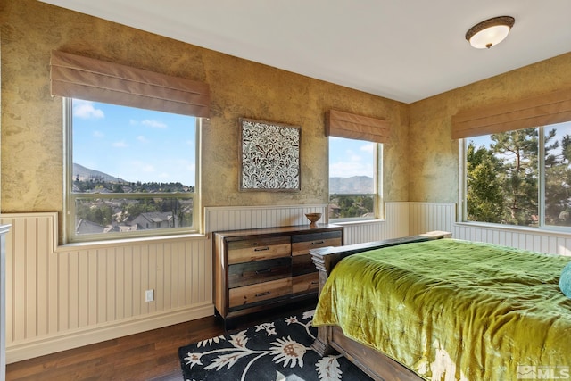 bedroom with dark hardwood / wood-style flooring