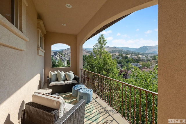 balcony featuring a mountain view and outdoor lounge area