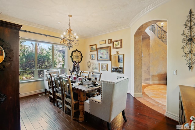 dining space featuring a notable chandelier, crown molding, and dark wood-type flooring