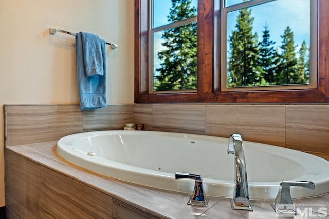 bathroom with a relaxing tiled tub