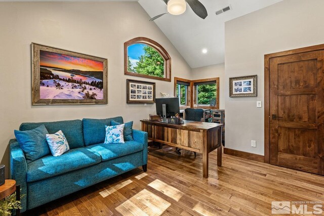 office area featuring ceiling fan, wood-type flooring, and high vaulted ceiling