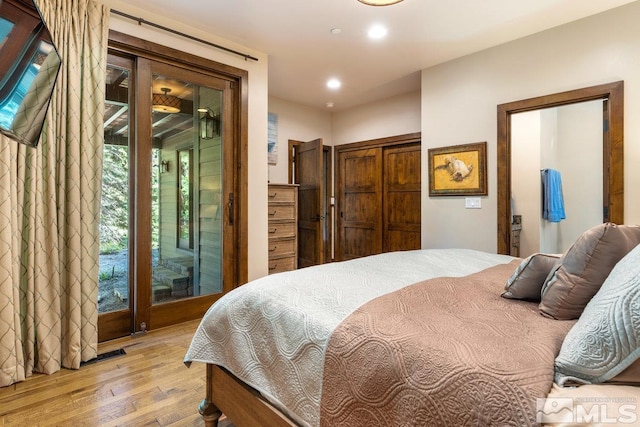 bedroom with access to outside and light hardwood / wood-style floors