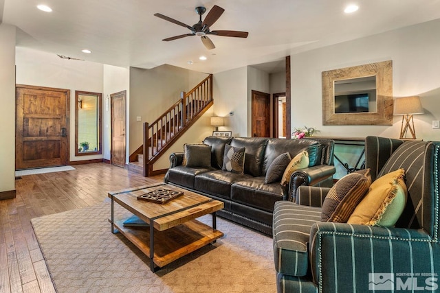 living room featuring light hardwood / wood-style floors and ceiling fan