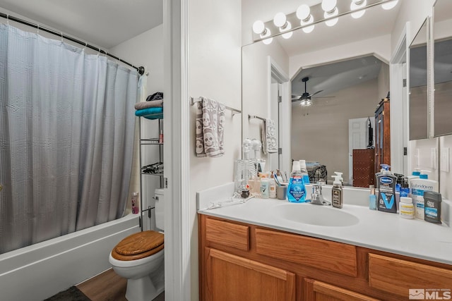 full bathroom featuring hardwood / wood-style flooring, shower / bath combination with curtain, toilet, vanity, and ceiling fan