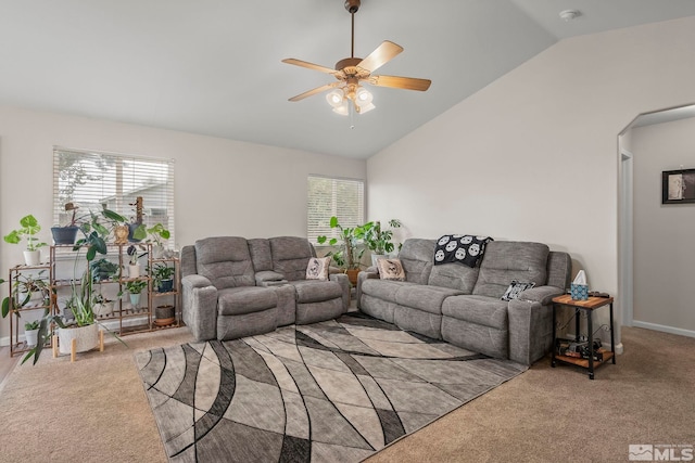 carpeted living room with a healthy amount of sunlight, vaulted ceiling, and ceiling fan