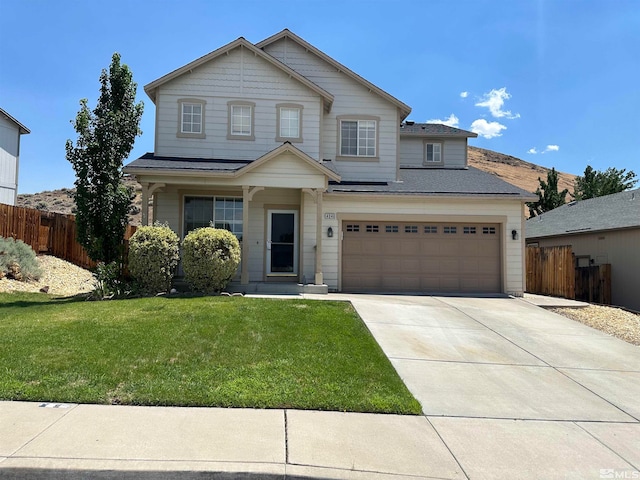 view of front of house with a garage and a front lawn