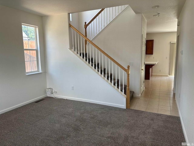 staircase with light colored carpet