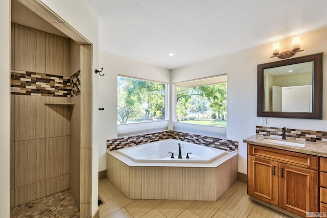 bathroom with tile patterned floors, vanity, and a bathtub