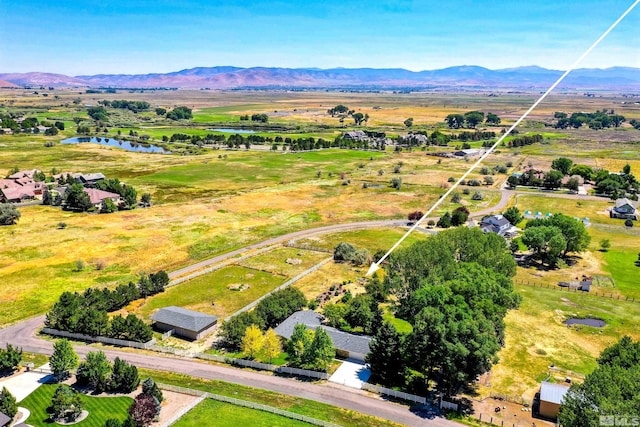 birds eye view of property featuring a water and mountain view and a rural view