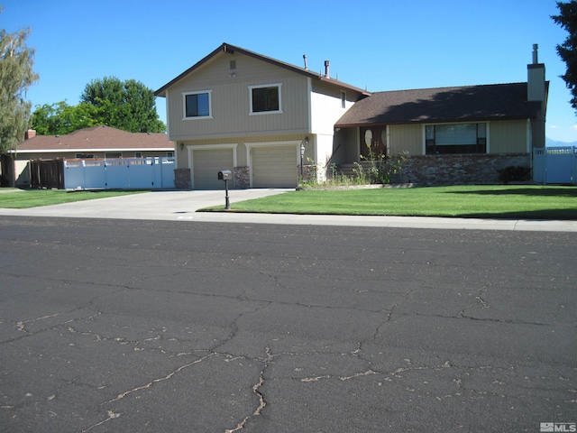 view of front of home featuring a garage and a front lawn