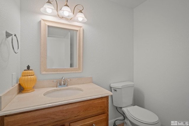 bathroom with toilet and vanity