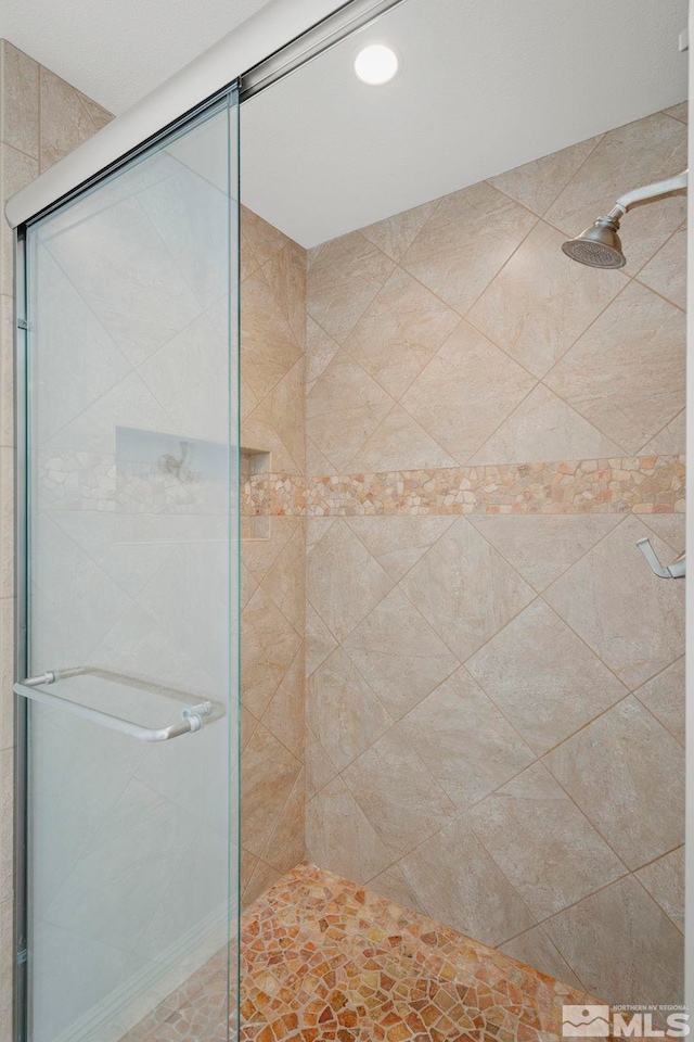 bathroom with a shower with shower door