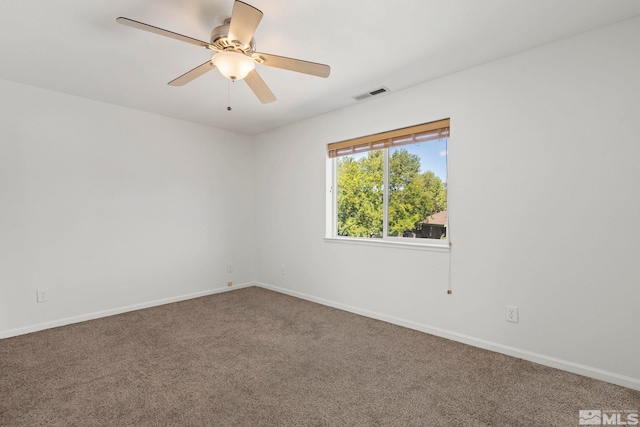 unfurnished room featuring ceiling fan and carpet floors