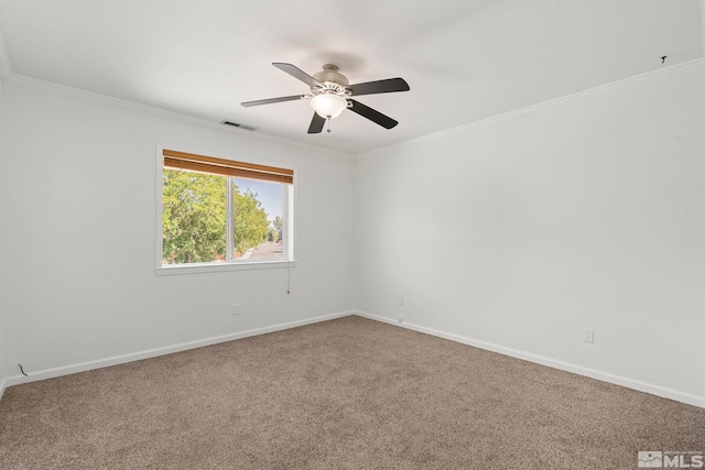 empty room featuring crown molding, ceiling fan, and carpet