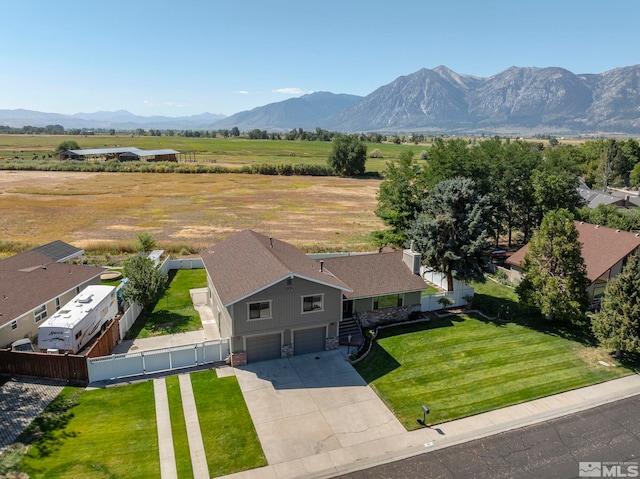 birds eye view of property with a mountain view and a rural view