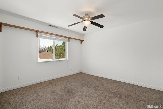 spare room with ceiling fan and carpet