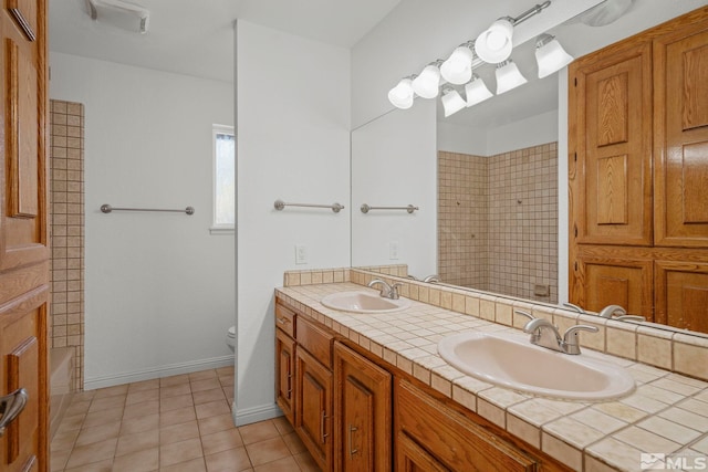 full bathroom with tile patterned floors, toilet, shower / washtub combination, and vanity