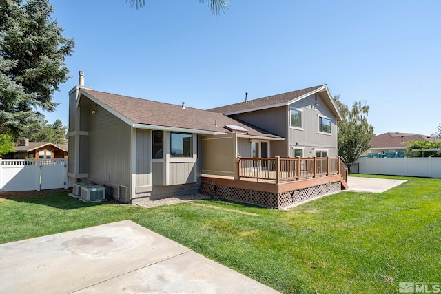 exterior space with a front yard, a patio area, and a wooden deck