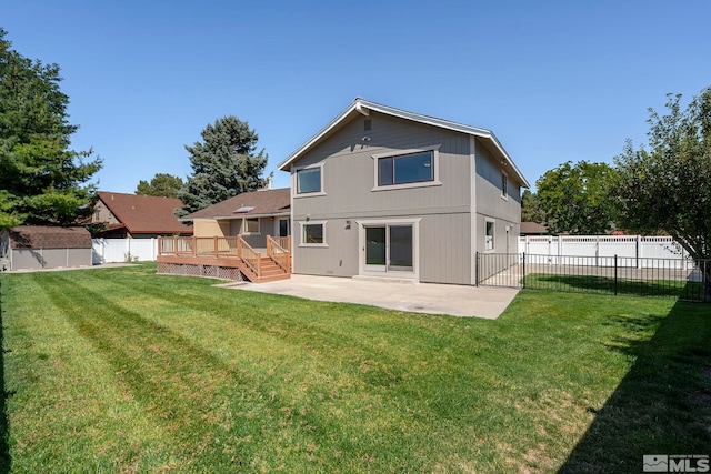 back of property featuring a yard, a patio, and a wooden deck