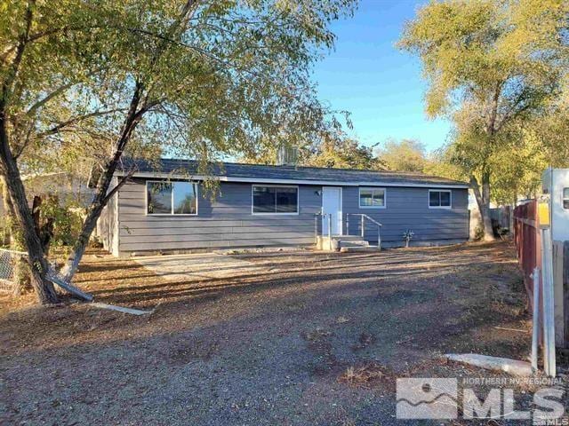 ranch-style house with fence