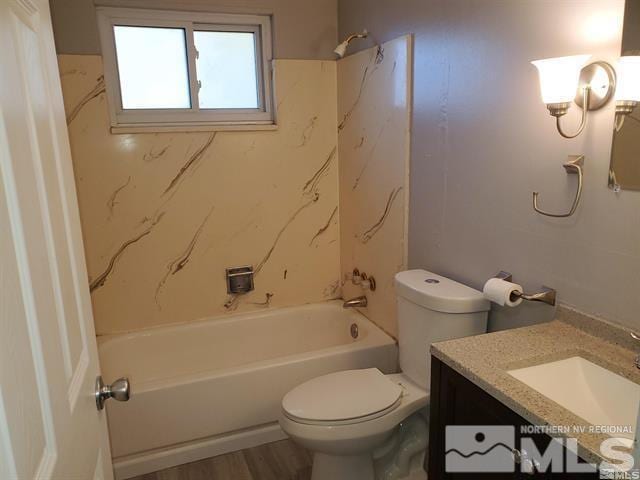 bathroom featuring toilet, shower / tub combination, wood finished floors, and vanity