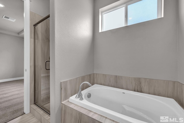 bathroom with separate shower and tub