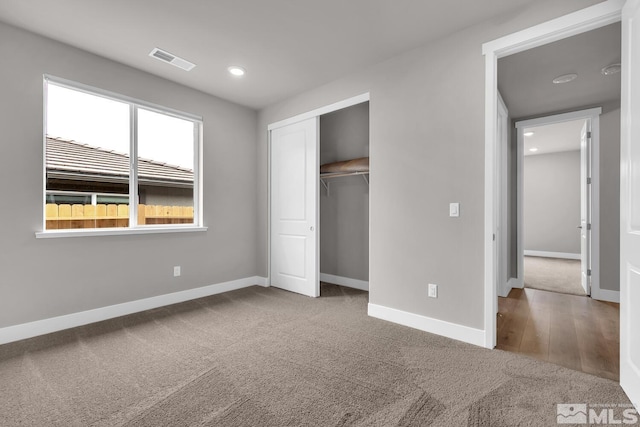 unfurnished bedroom with carpet flooring and a closet