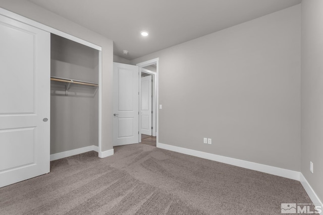 unfurnished bedroom with a closet and carpet