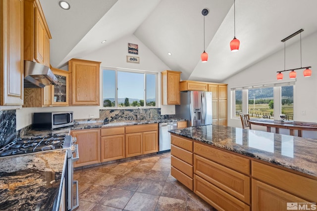 kitchen featuring stainless steel appliances, dark tile patterned floors, wall chimney exhaust hood, sink, and backsplash