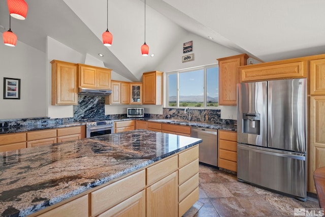 kitchen with pendant lighting, high vaulted ceiling, dark stone countertops, appliances with stainless steel finishes, and light tile patterned floors