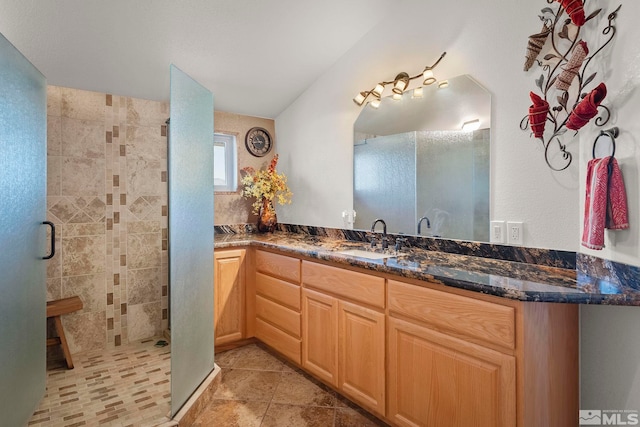 bathroom featuring vanity, tile patterned flooring, and walk in shower