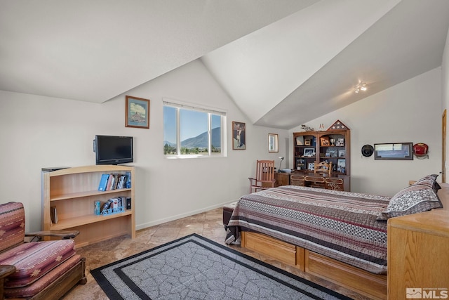 tiled bedroom featuring vaulted ceiling