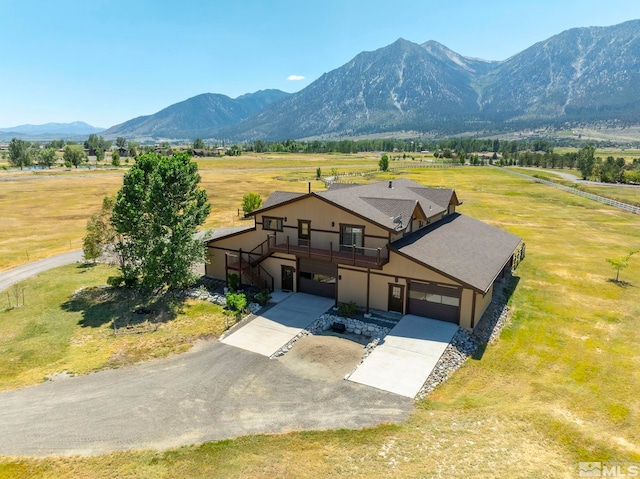 birds eye view of property featuring a mountain view and a rural view