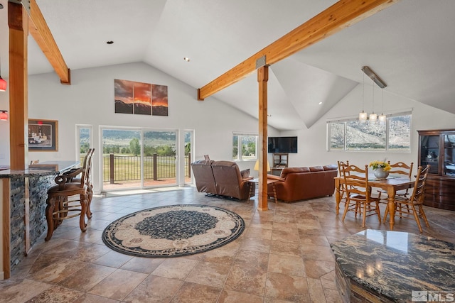 tiled living room with an inviting chandelier, high vaulted ceiling, and beam ceiling