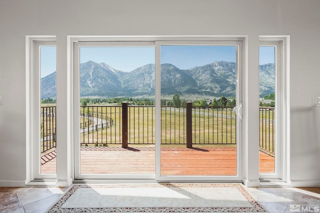 entryway with a mountain view, tile patterned floors, and plenty of natural light