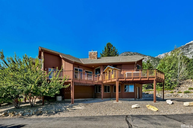 view of property featuring a deck with mountain view