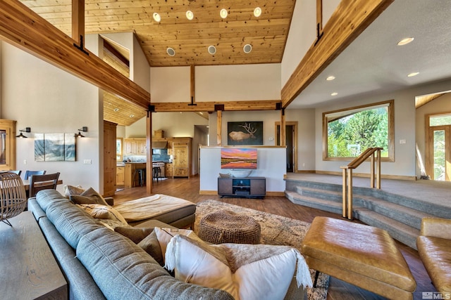 living room with hardwood / wood-style floors and high vaulted ceiling