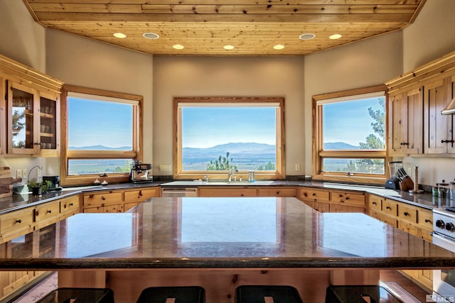 kitchen featuring wood ceiling, a mountain view, and dark stone countertops