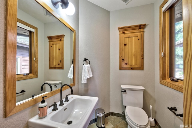 bathroom with sink, tile patterned floors, and toilet