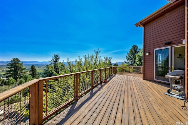 wooden terrace featuring a mountain view and grilling area