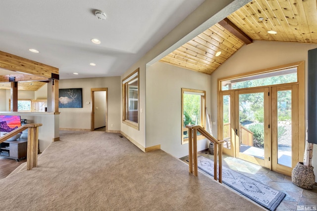 carpeted foyer with wood ceiling and vaulted ceiling with beams