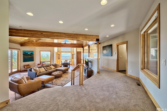 carpeted living room featuring beam ceiling