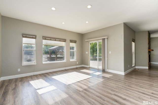 spare room with light hardwood / wood-style flooring